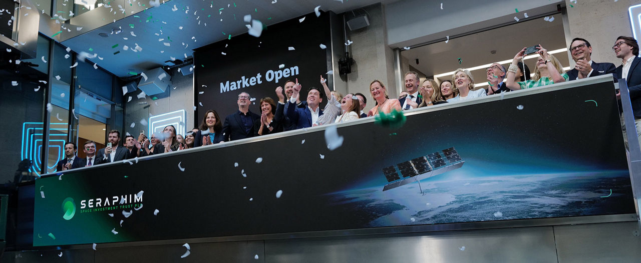 The team celebrating on the balcony at LSEG during the welcome ceremony.