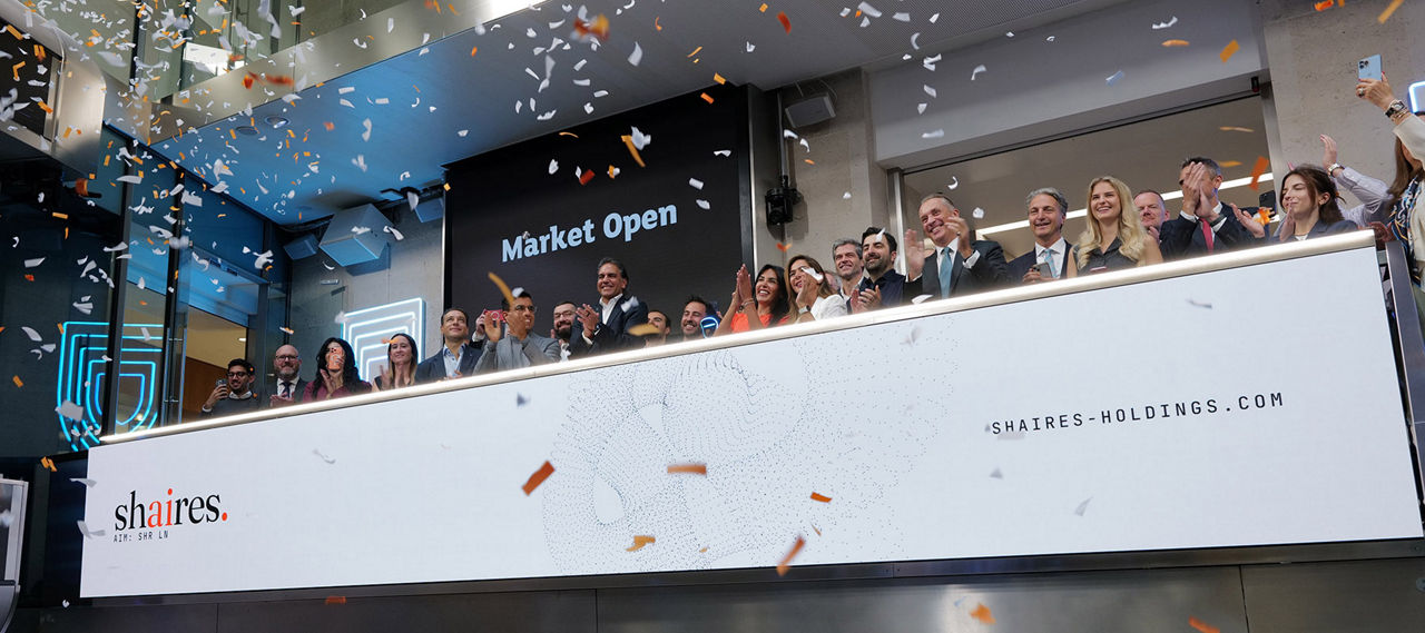 The team celebrating on the balcony at LSEG during the welcome ceremony.