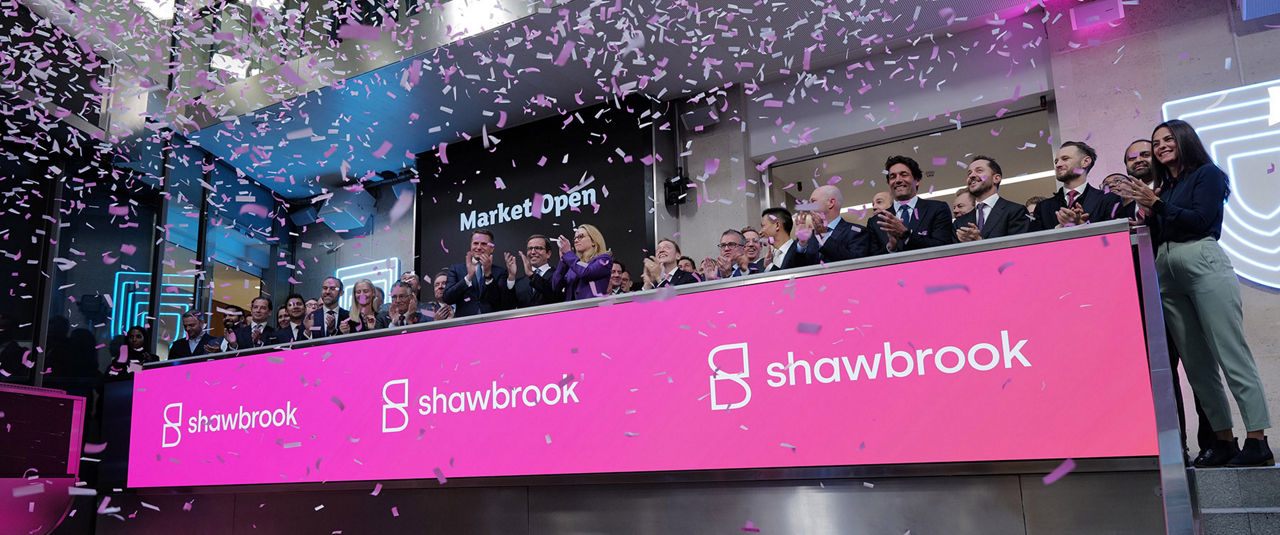 The team celebrating on the balcony at LSEG during the welcome ceremony.