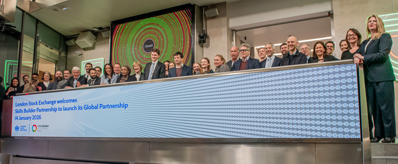 The team celebrating on the balcony at LSEG during the welcome ceremony.