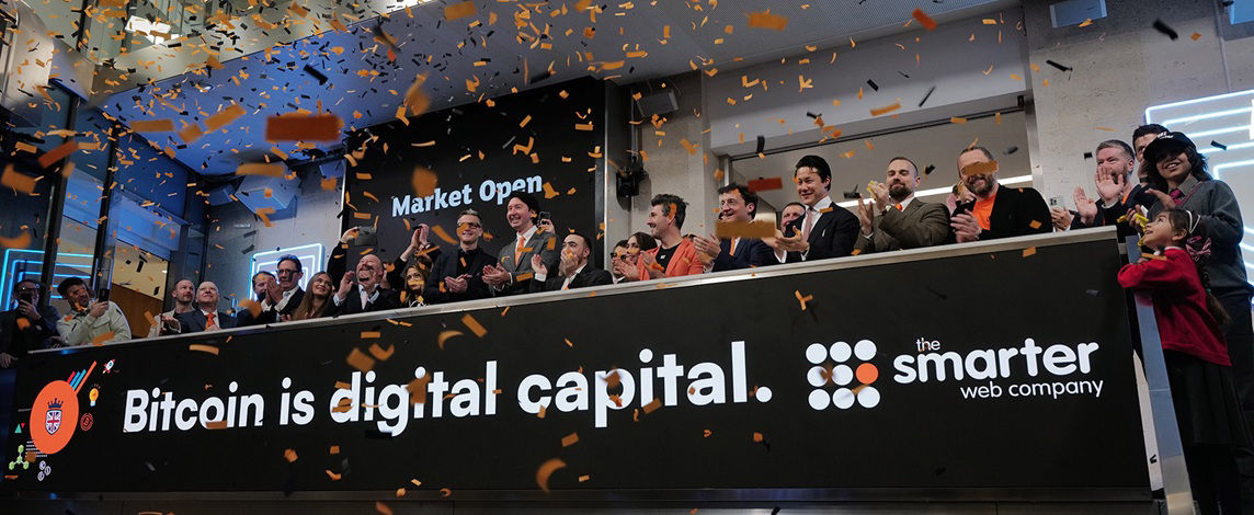 The team celebrating on the balcony at LSEG during the welcome ceremony.