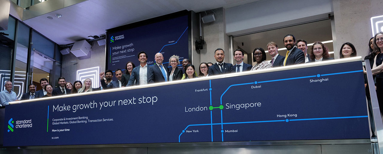 The team celebrating on the balcony at LSEG during the welcome ceremony.