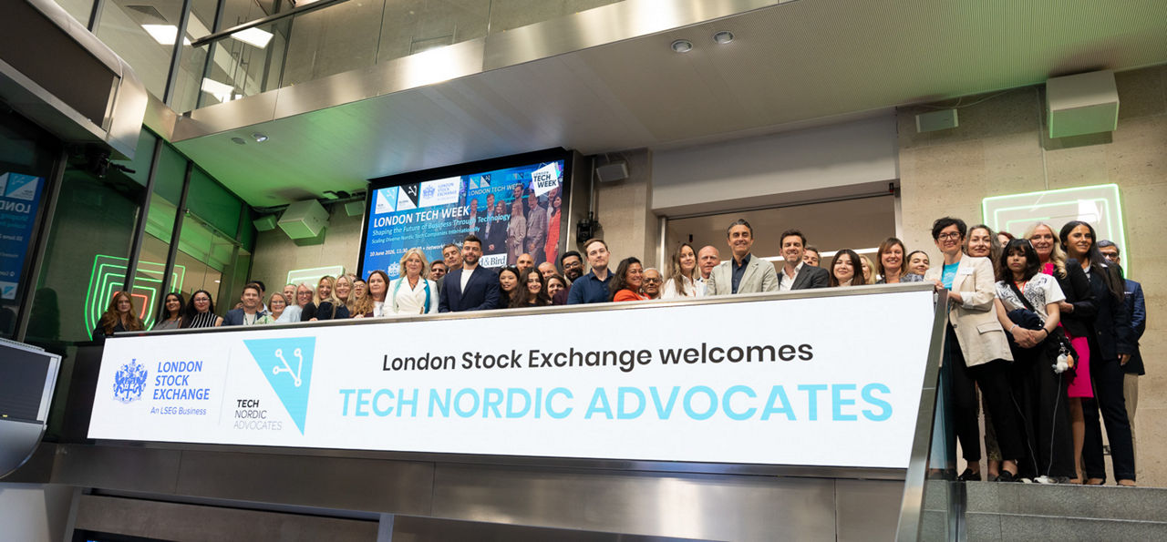 The team celebrating on the balcony at LSEG during the welcome ceremony.