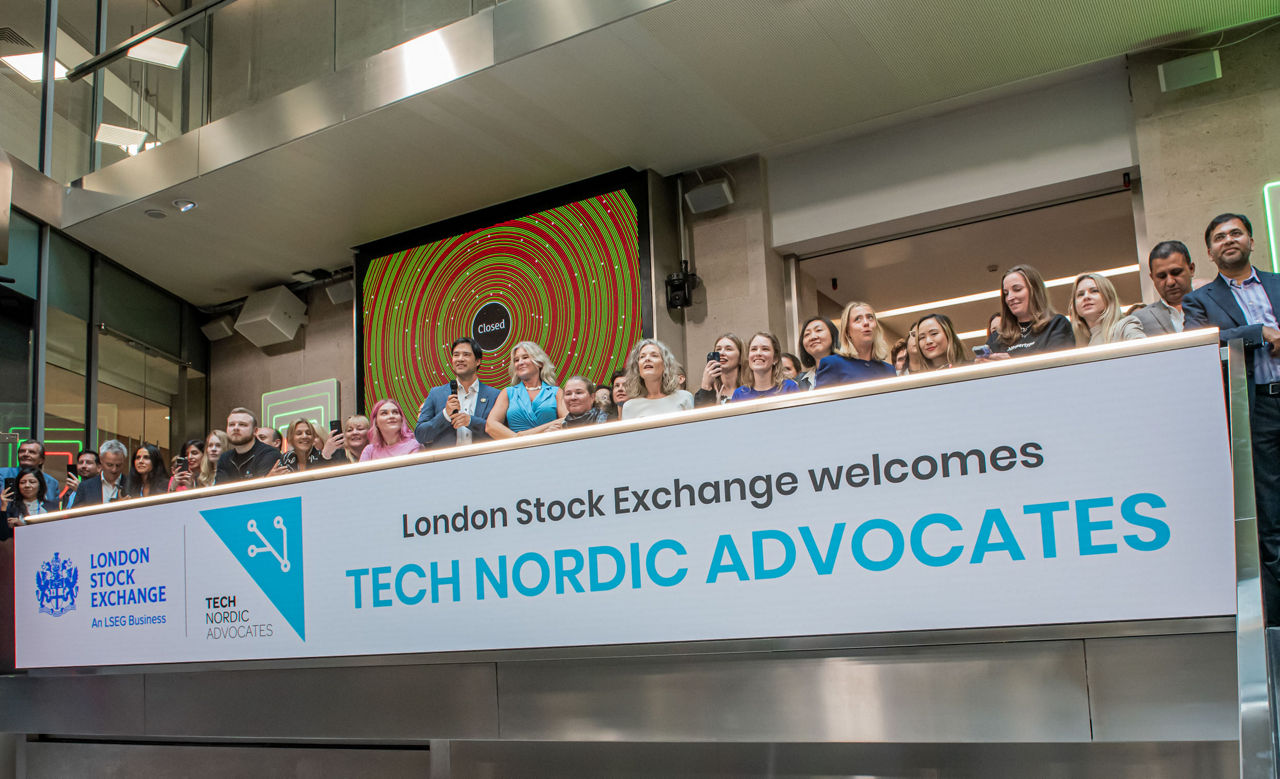 The team celebrating on the balcony at LSEG during the welcome ceremony.