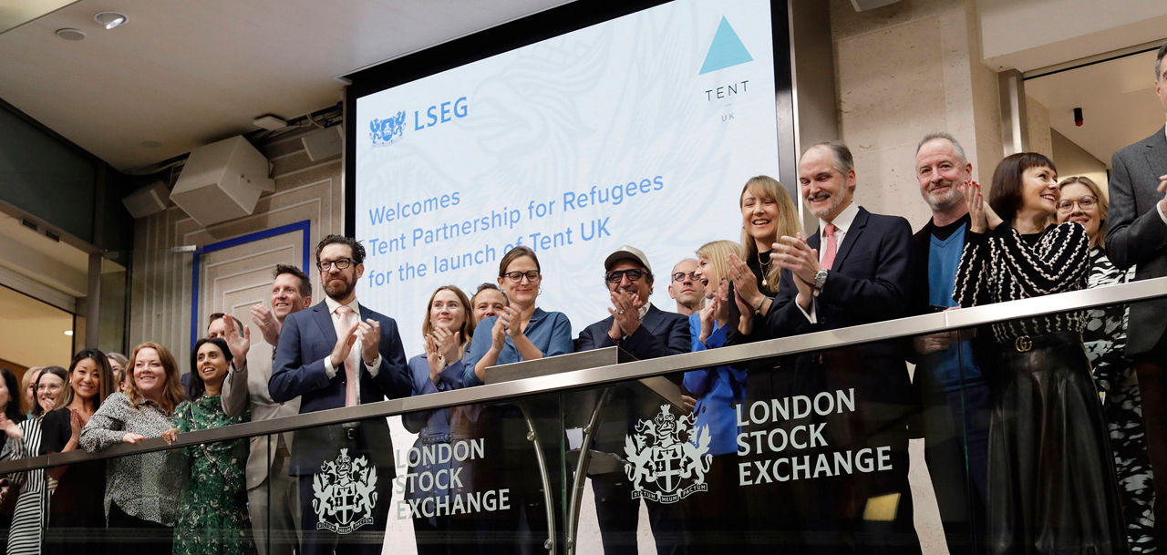 The team celebrating on the balcony at LSEG during the welcome ceremony.