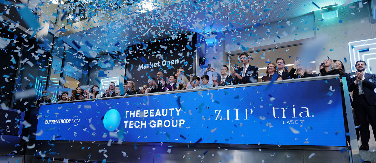 The team celebrating on the balcony at LSEG during the welcome ceremony