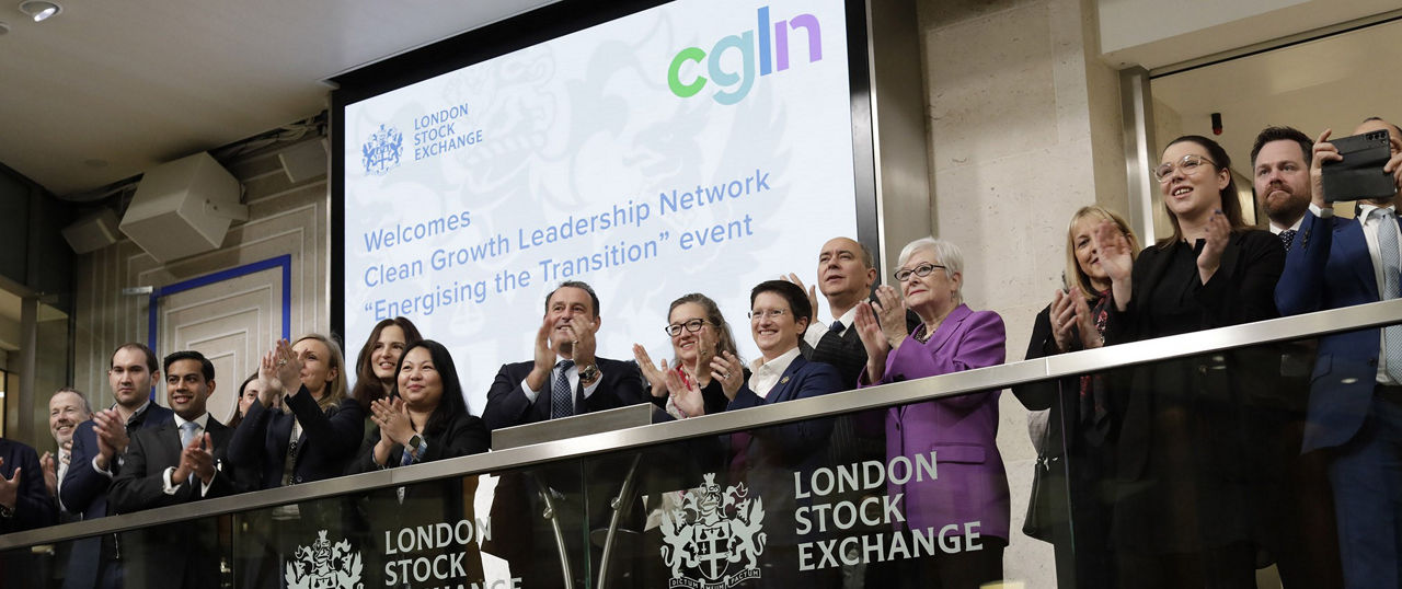 The team celebrating on the balcony at LSEG during the welcome ceremony.