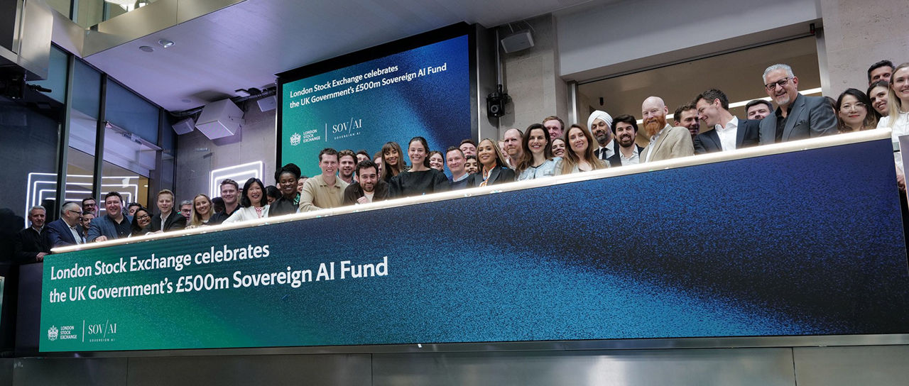 The team celebrating on the balcony at LSEG during the welcome ceremony.