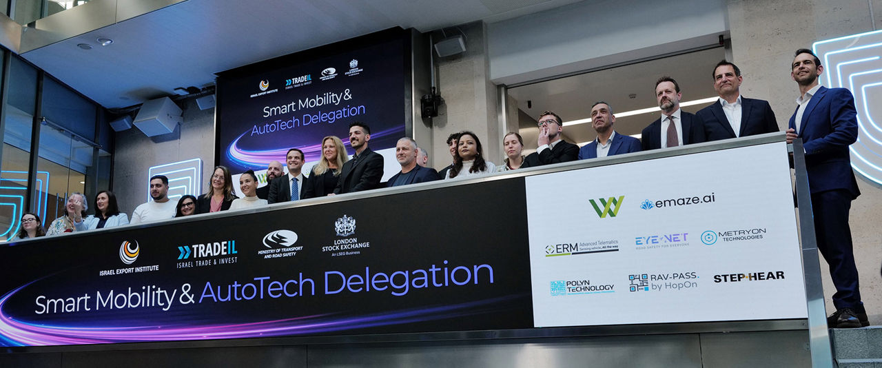 The team celebrating on the balcony at LSEG during the welcome ceremony.