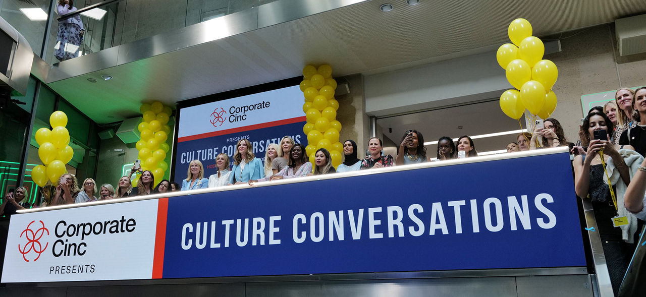 The team celebrating on the balcony at LSEG during the welcome ceremony.