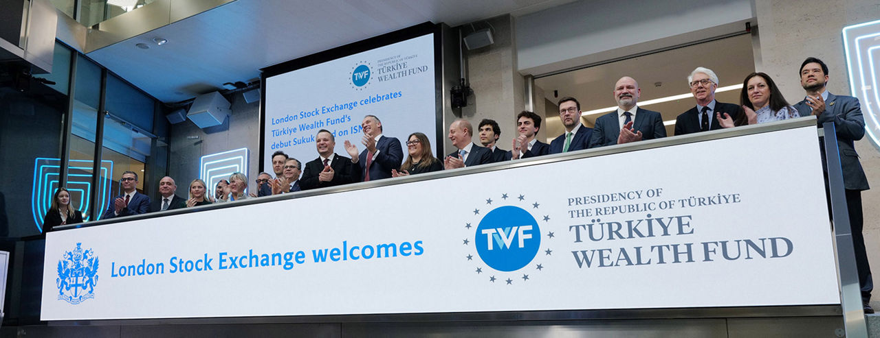 The team celebrating on the balcony at LSEG during the welcome ceremony.