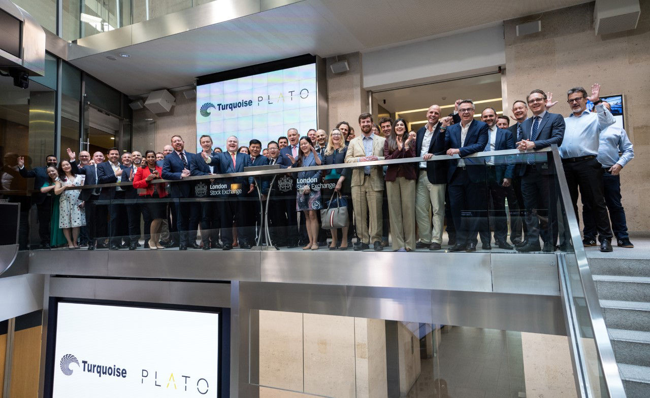 The team celebrating on the balcony at LSEG during the welcome ceremony.