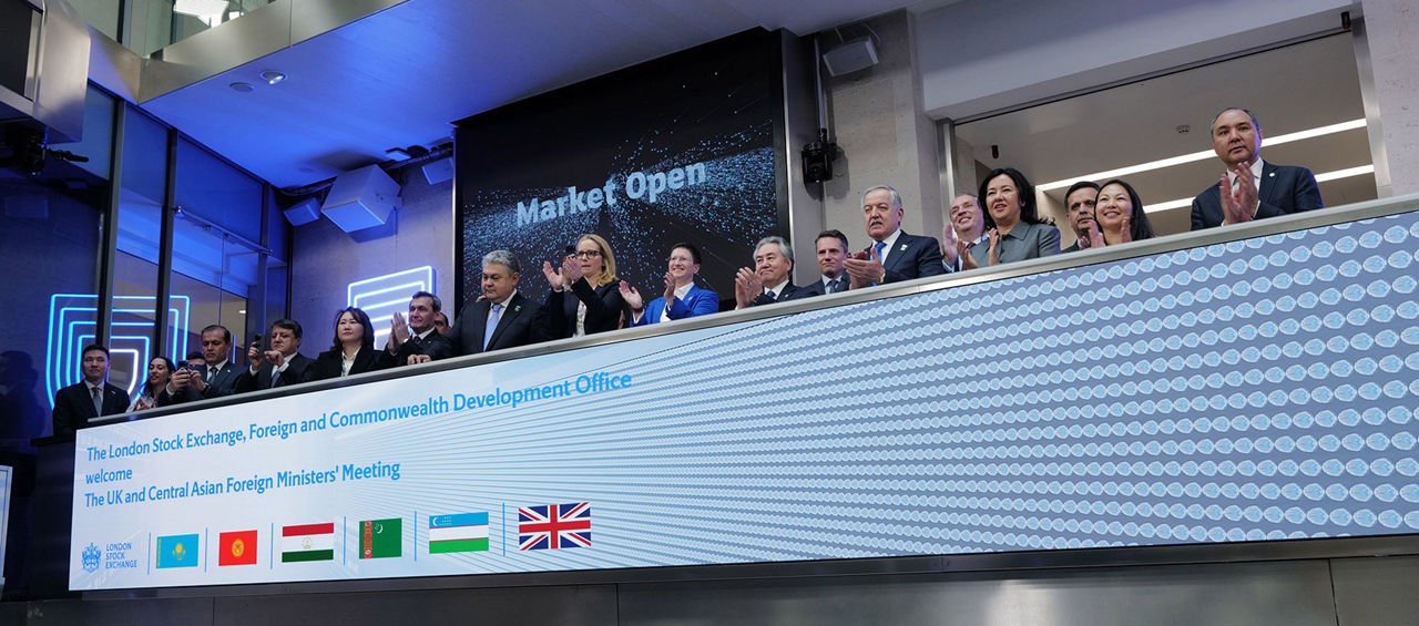 The team celebrating on the balcony at LSEG during the welcome ceremony.