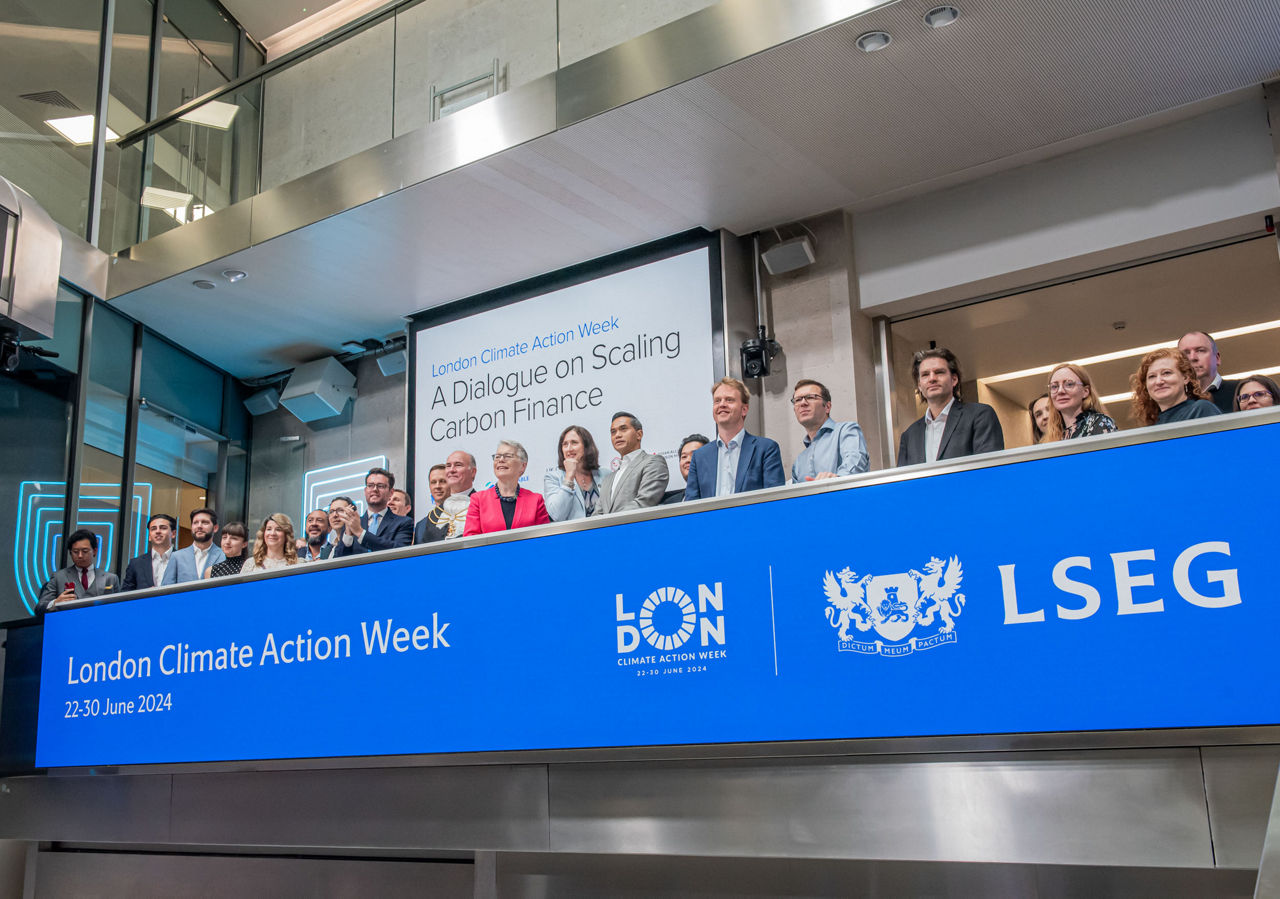 The team celebrating on the balcony at LSEG during the welcome ceremony.