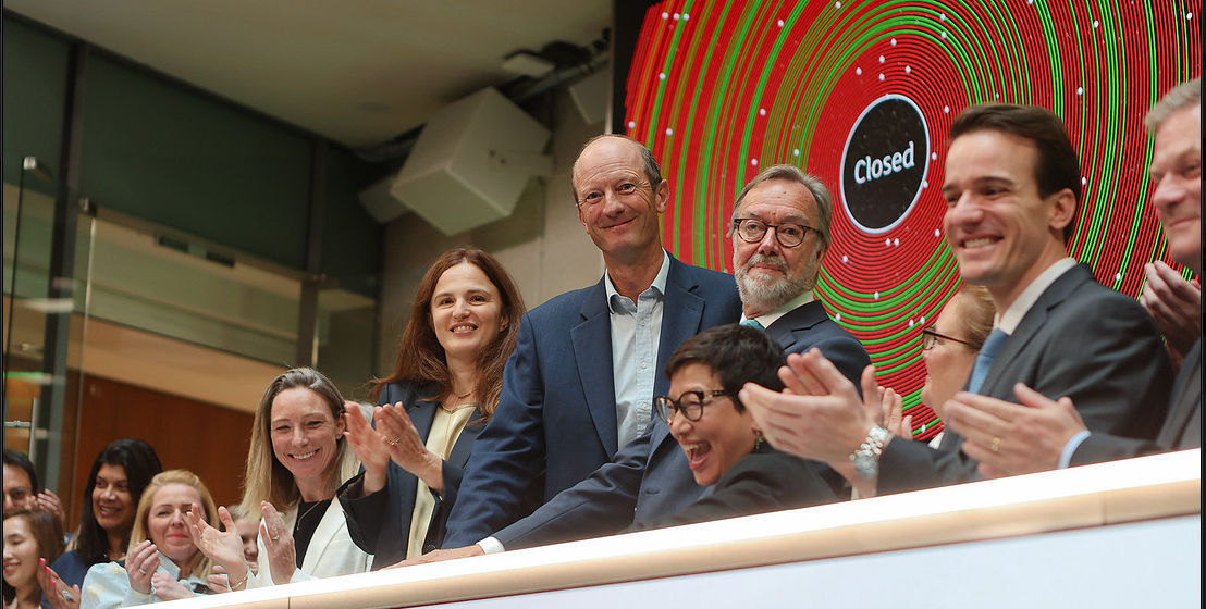 The team celebrating on the balcony at LSEG during the welcome ceremony.