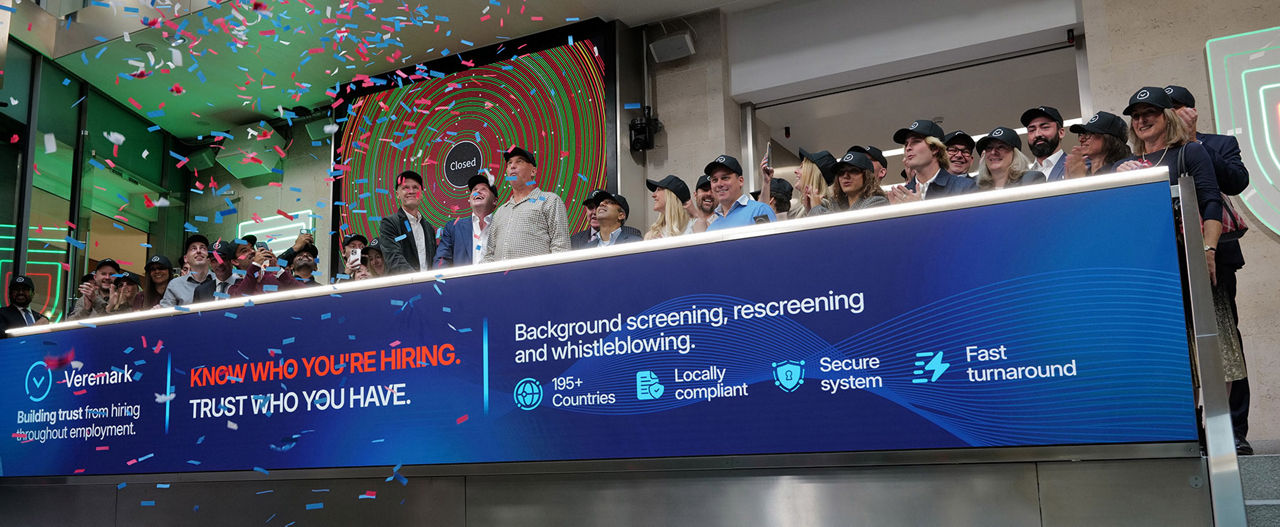 The team celebrating on the balcony at LSEG during the welcome ceremony.