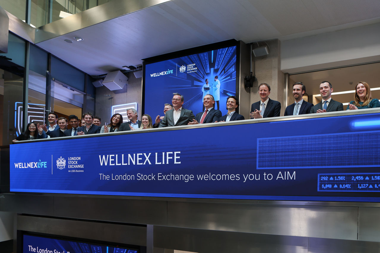 The team celebrating on the balcony at LSEG during the welcome ceremony.