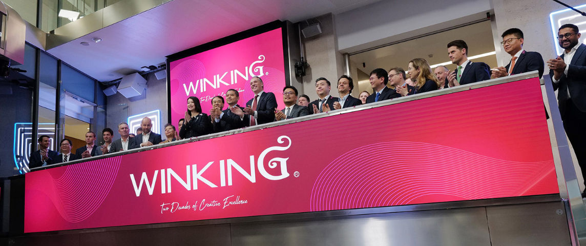 The team celebrating on the balcony at LSEG during the welcome ceremony.