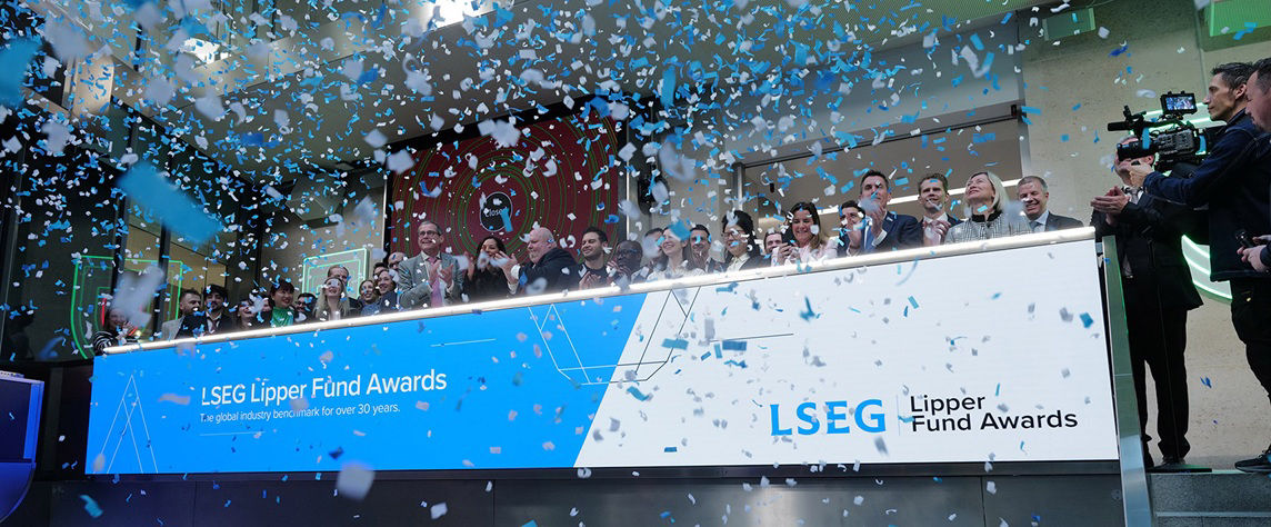 The team celebrating on the balcony at LSEG during the welcome ceremony.