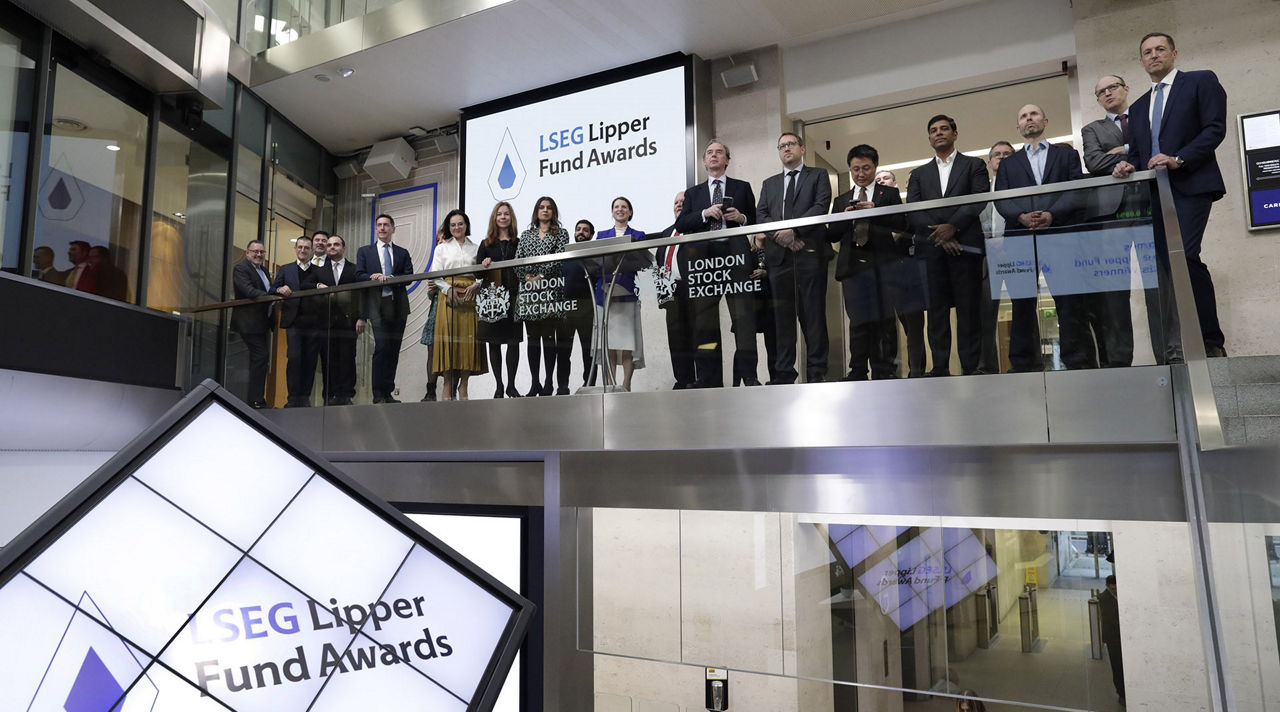 The team celebrating on the balcony at LSEG during the welcome ceremony.