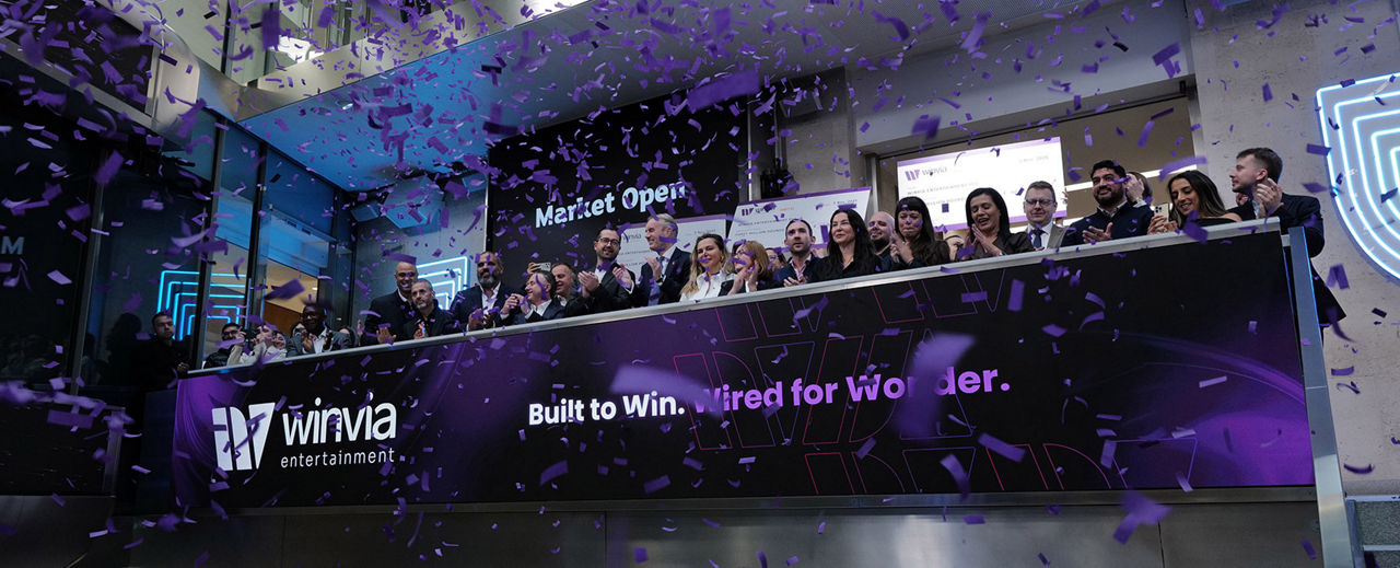 The team celebrating on the balcony at LSEG during the welcome ceremony.