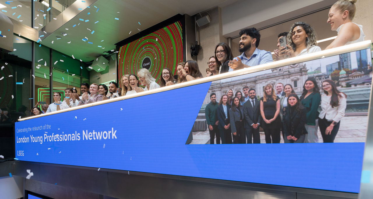 The team celebrating on the balcony at LSEG during the welcome ceremony.