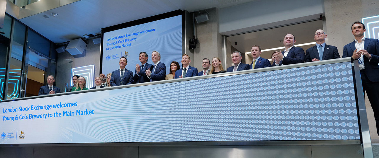 The team celebrating on the balcony at LSEG during the welcome ceremony.