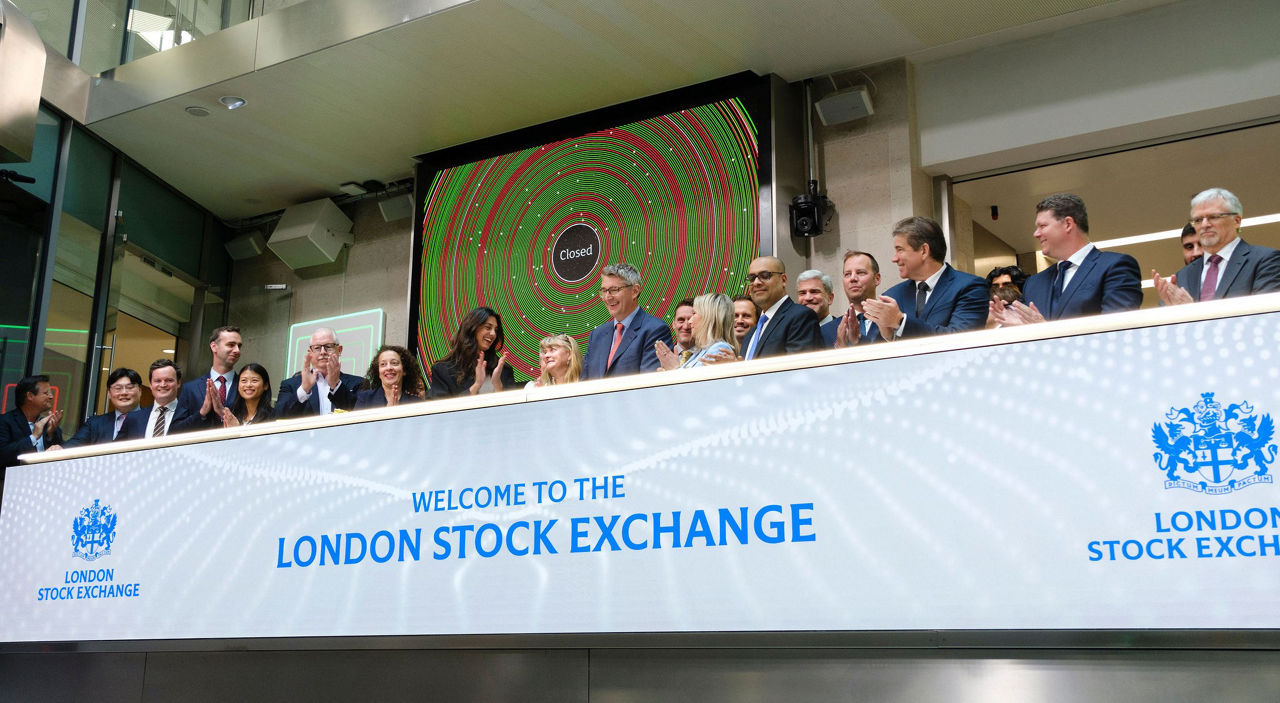The team celebrating on the balcony at LSEG during the welcome ceremony.