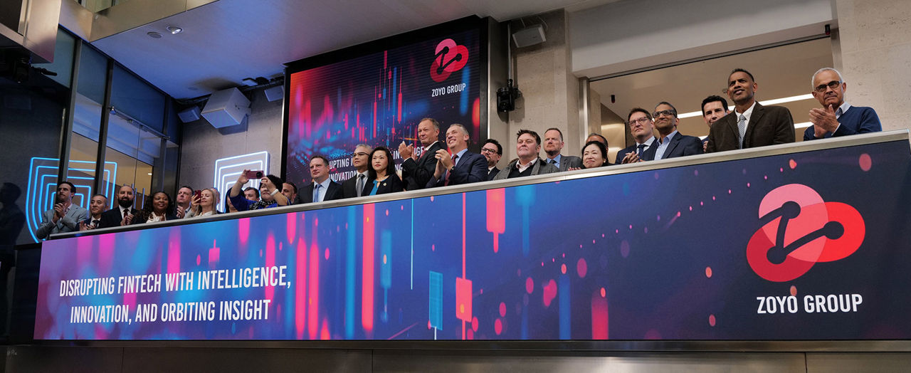 The team celebrating on the balcony at LSEG during the welcome ceremony